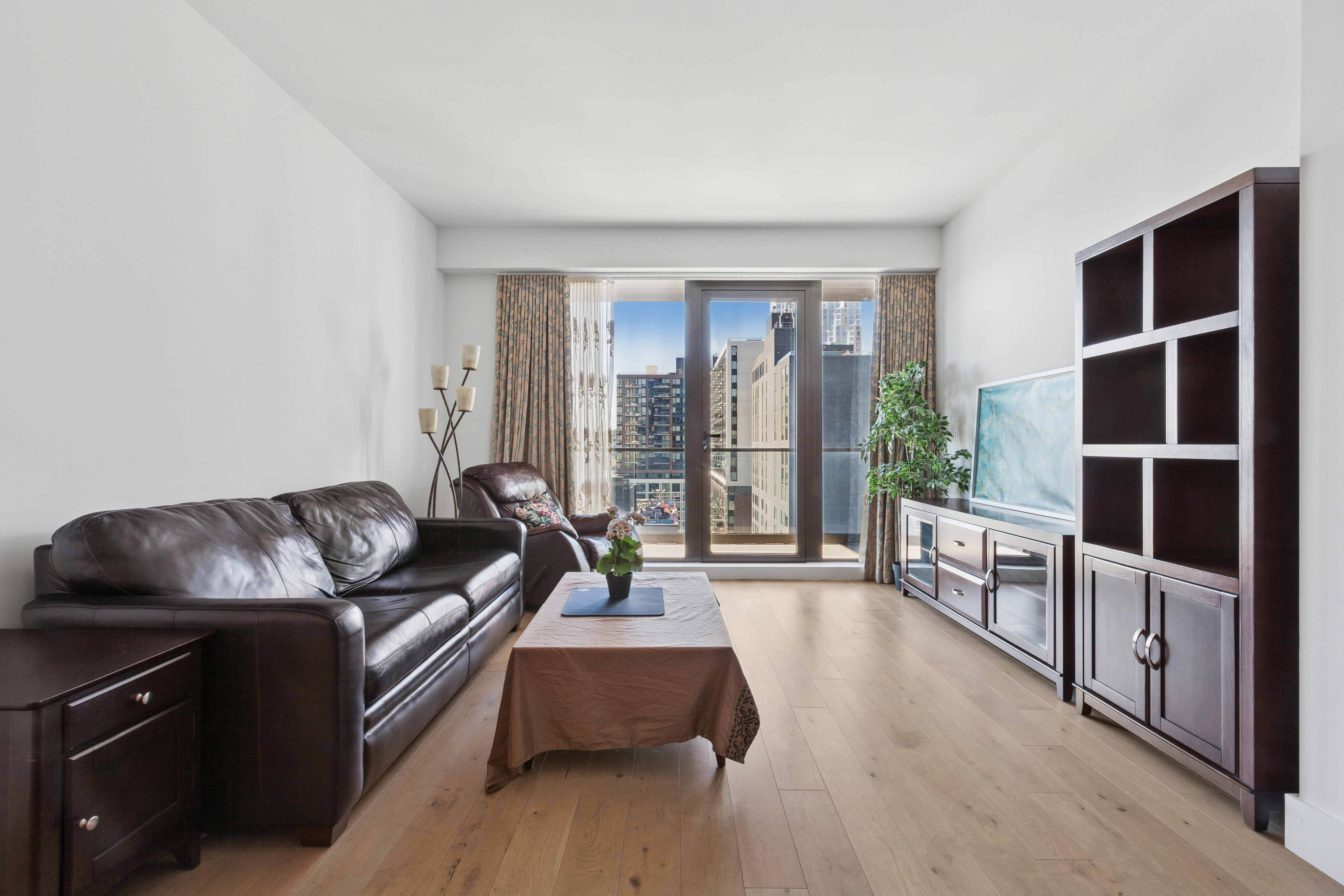 319 Schermerhorn Street, Unit 19B Brooklyn, NY 11217 - Photo 1 of 13 a living room with furniture and a flat screen tv
