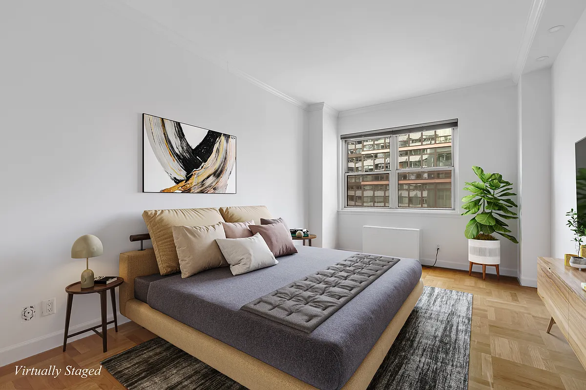 200 East 58th Street, Unit 15B Manhattan, NY 10022 - Photo 7 of 10 a bedroom with furniture and a window