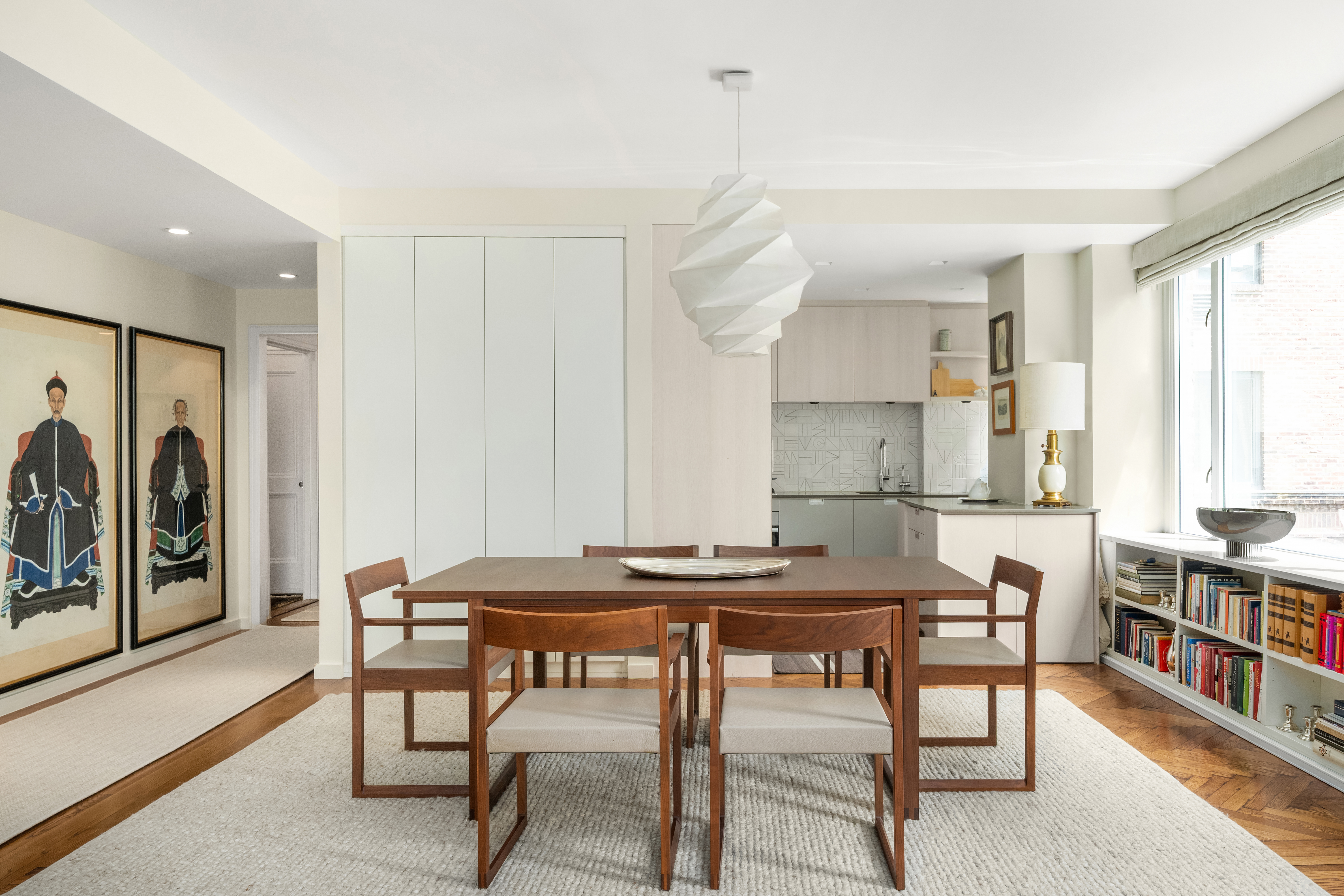 455 East 51st Street, Unit 2F Manhattan, NY 10022 - Photo 5 of 17 a view of a dining room with furniture and a book shelf