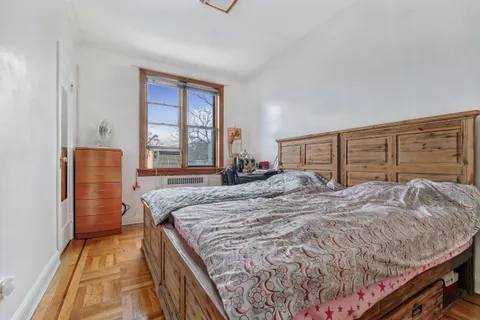 a bed sitting in a bedroom and a dresser