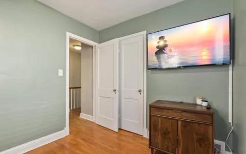 a view of a room with wooden floor and cabinet