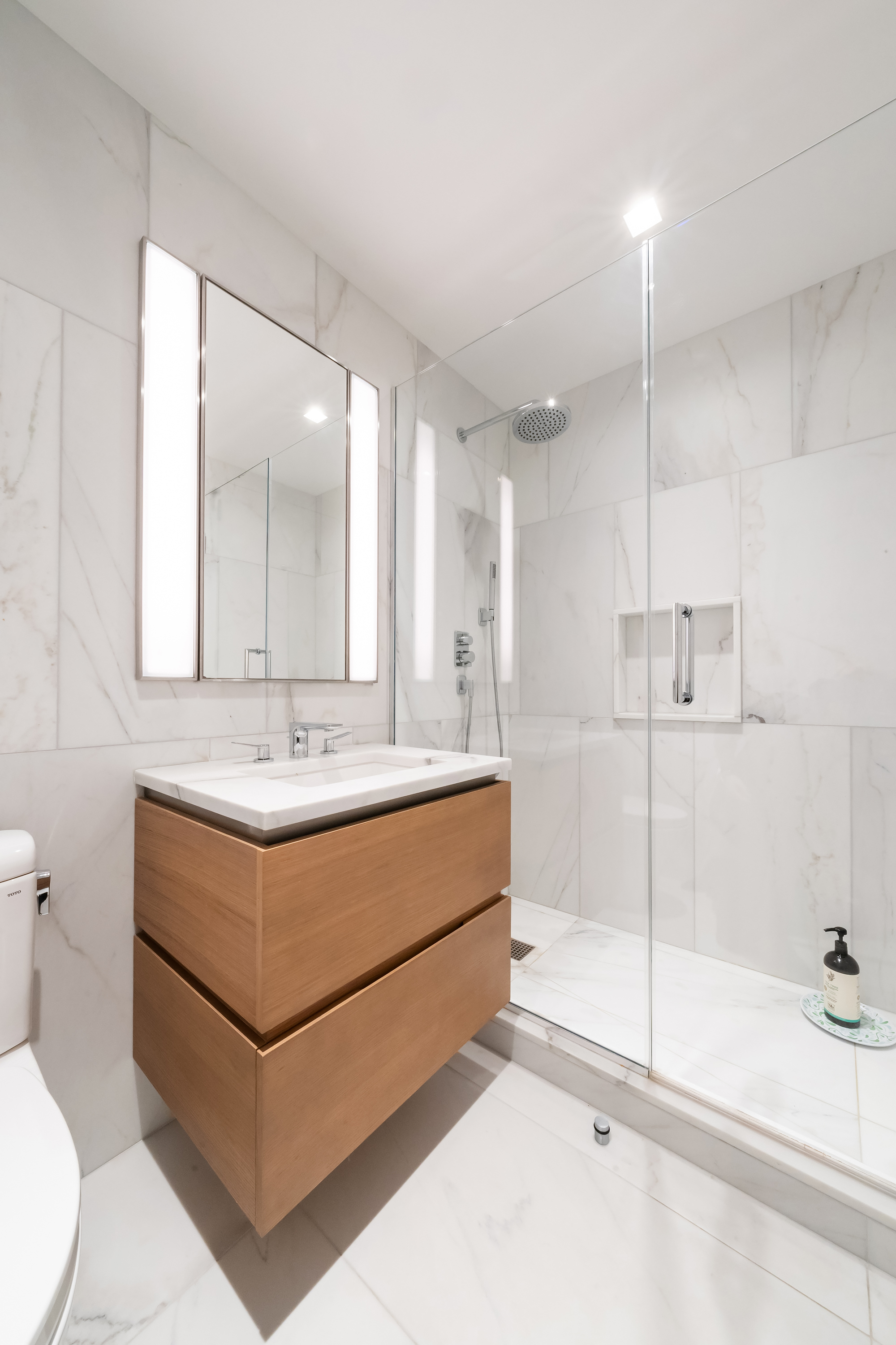 450 Washington Street, Unit 517 Manhattan, NY 10013 - Photo 5 of 11 a bathroom with a sink mirror toilet and bathtub