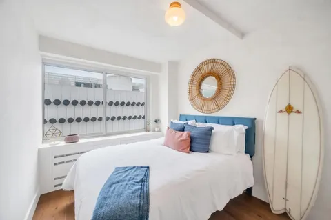 a bedroom with a bed and window