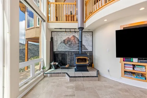 a living room with furniture a couch and a large window