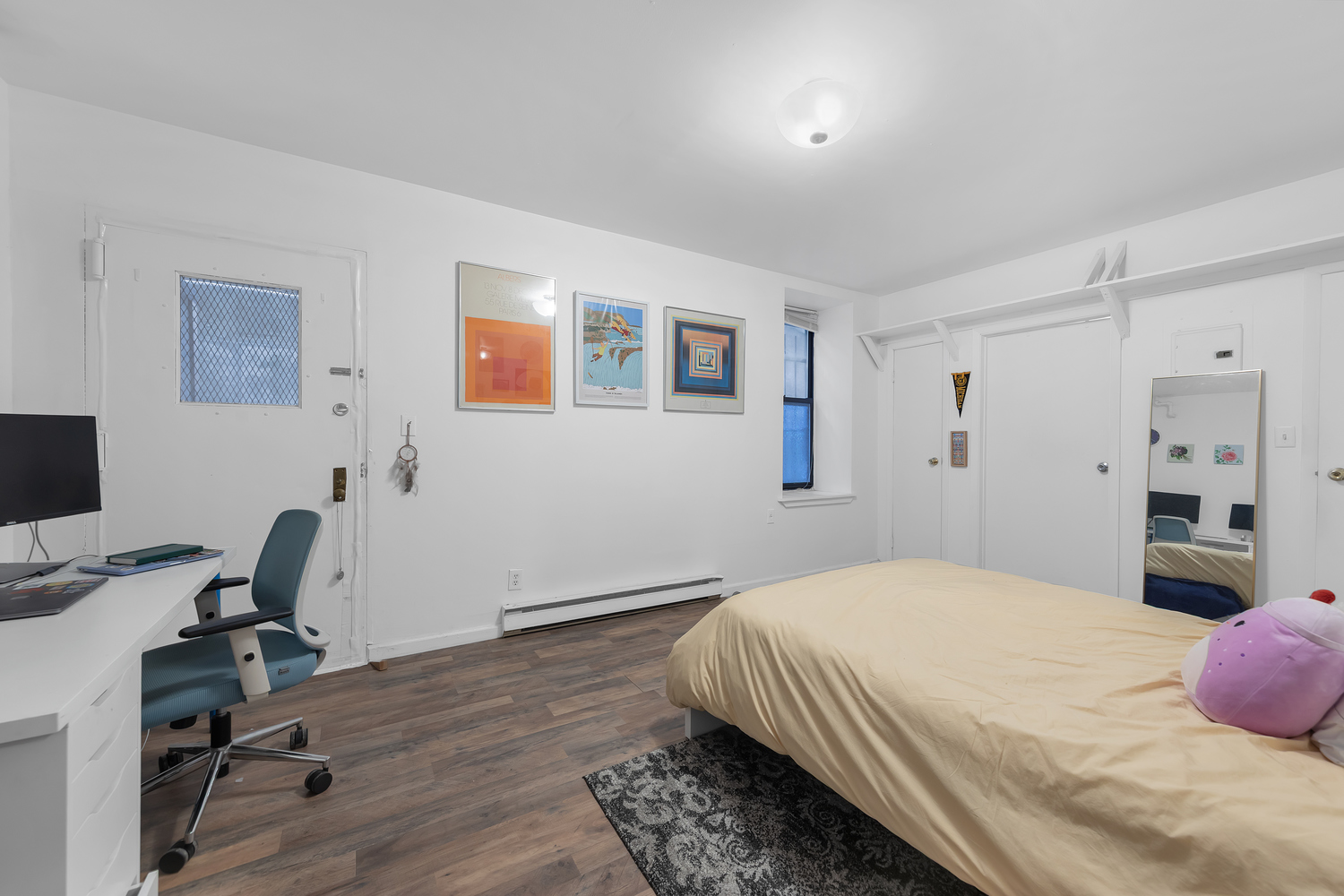 224 East 11th Street, Unit GARDEN Manhattan, NY 10003 - Photo 3 of 6 a bedroom with a bed and a desk