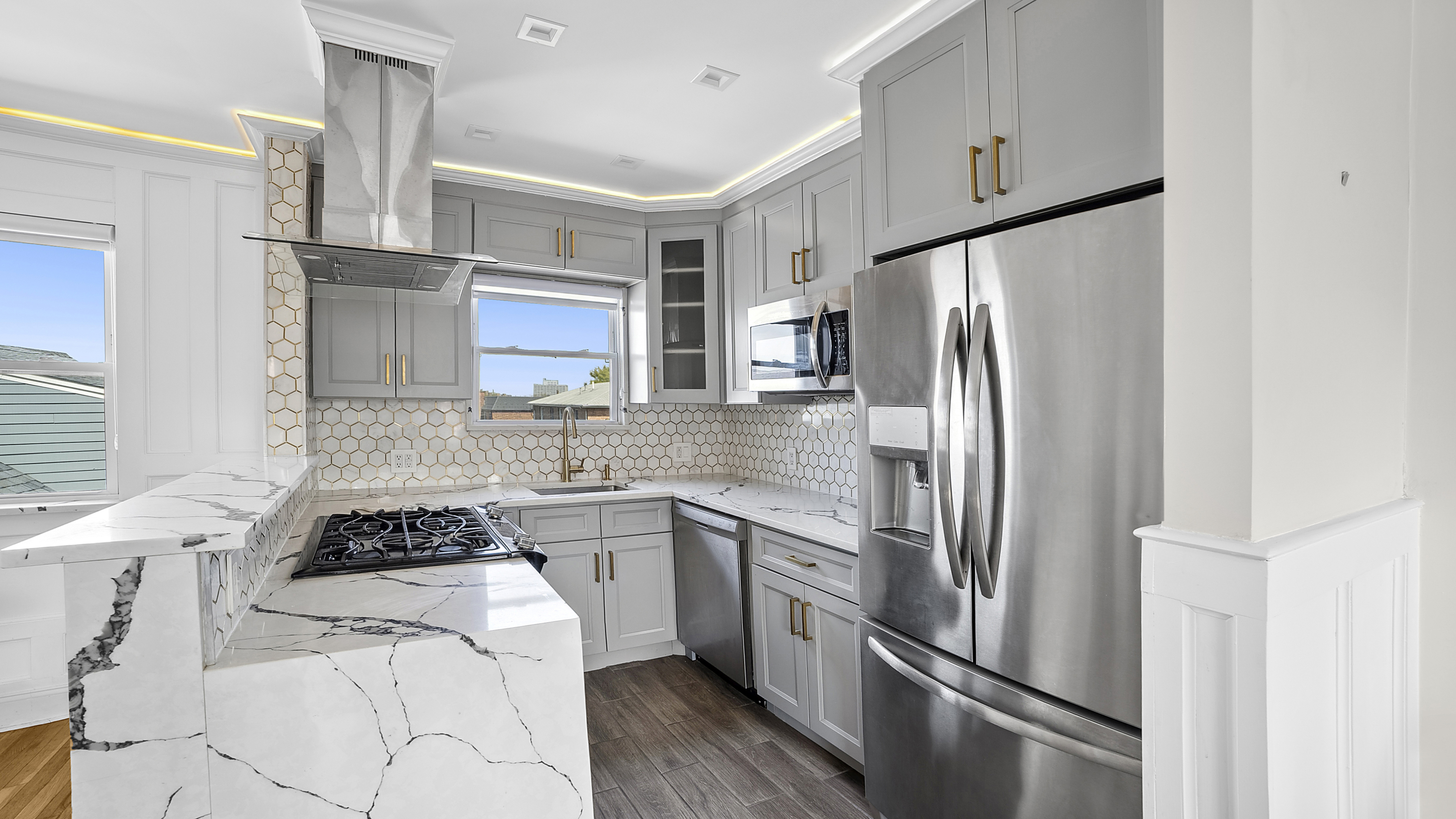 a kitchen with stainless steel appliances a refrigerator sink and cabinets