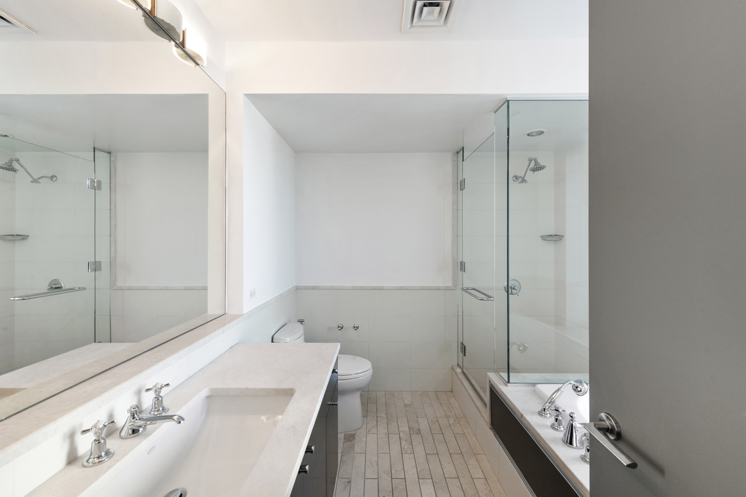 207 East 57th Street, Unit 34A Manhattan, NY 10022 - Photo 12 of 22 a bathroom with a bathtub and a sink