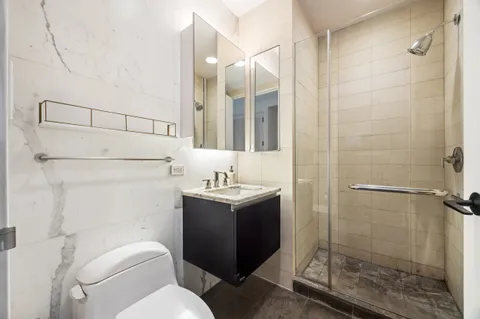 a bathroom with a sink toilet and shower