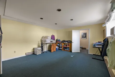 a view of a dirt road with large trees
