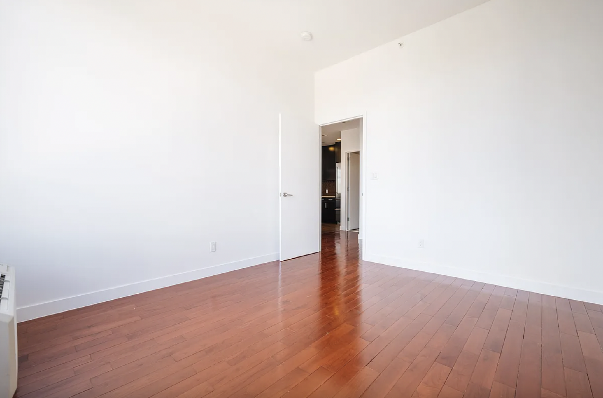 42-37 27th Street, Unit 8B Queens, NY 11101 - Photo 5 of 11 a view of an empty room with wooden floor