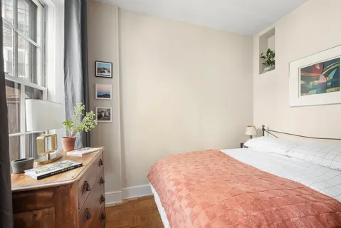 a bedroom with a bed and a desk