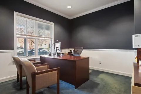 a dining room with furniture and window