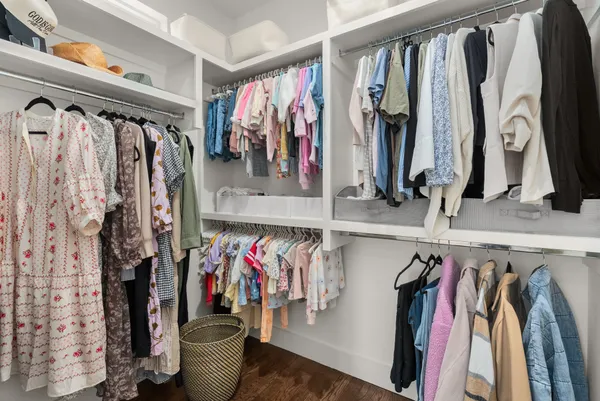 a view of walk in closet with clothes