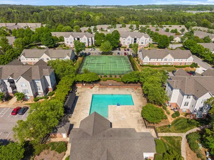 an aerial view of residential houses with outdoor space and river view