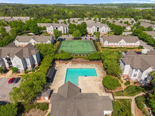 an aerial view of residential houses with outdoor space and river view