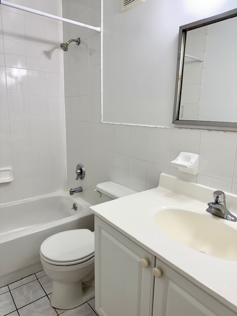 30-18 33rd Street, Unit 2F Queens, NY 11102 - Photo 6 of 6 a bathroom with a sink a toilet and shower