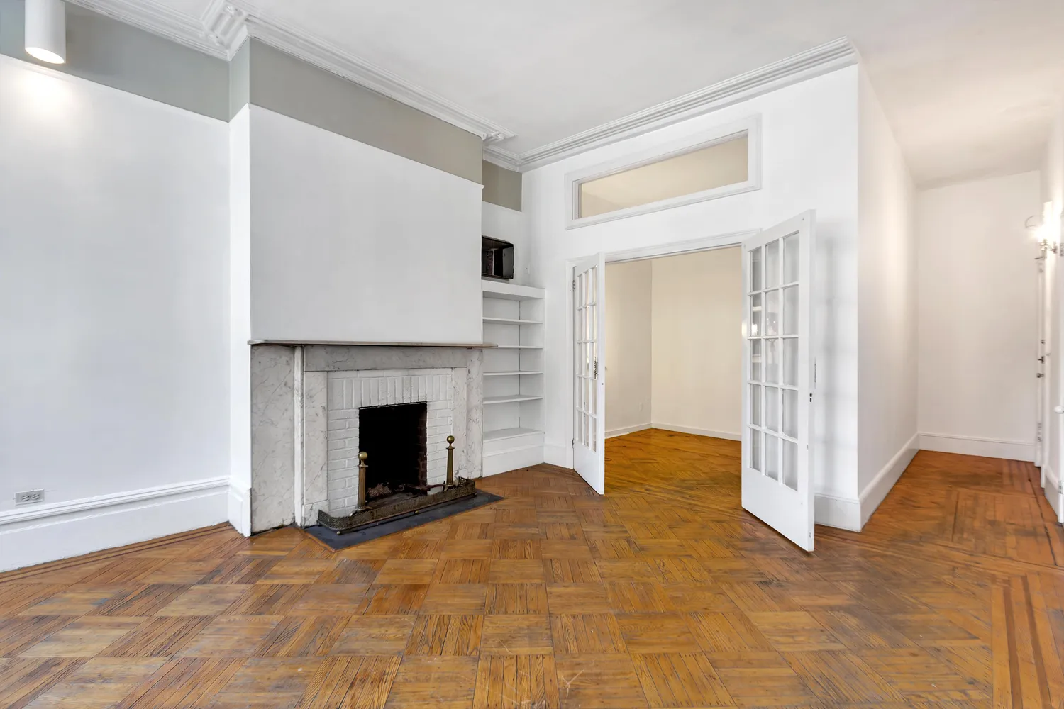 a view of an empty room with fireplace and a window