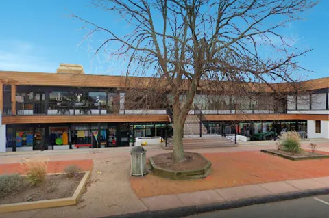 a swimming pool with outdoor seating and city view