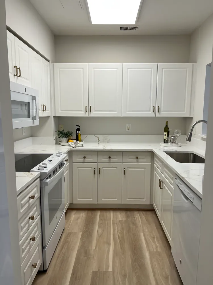 a kitchen with cabinets appliances and a sink