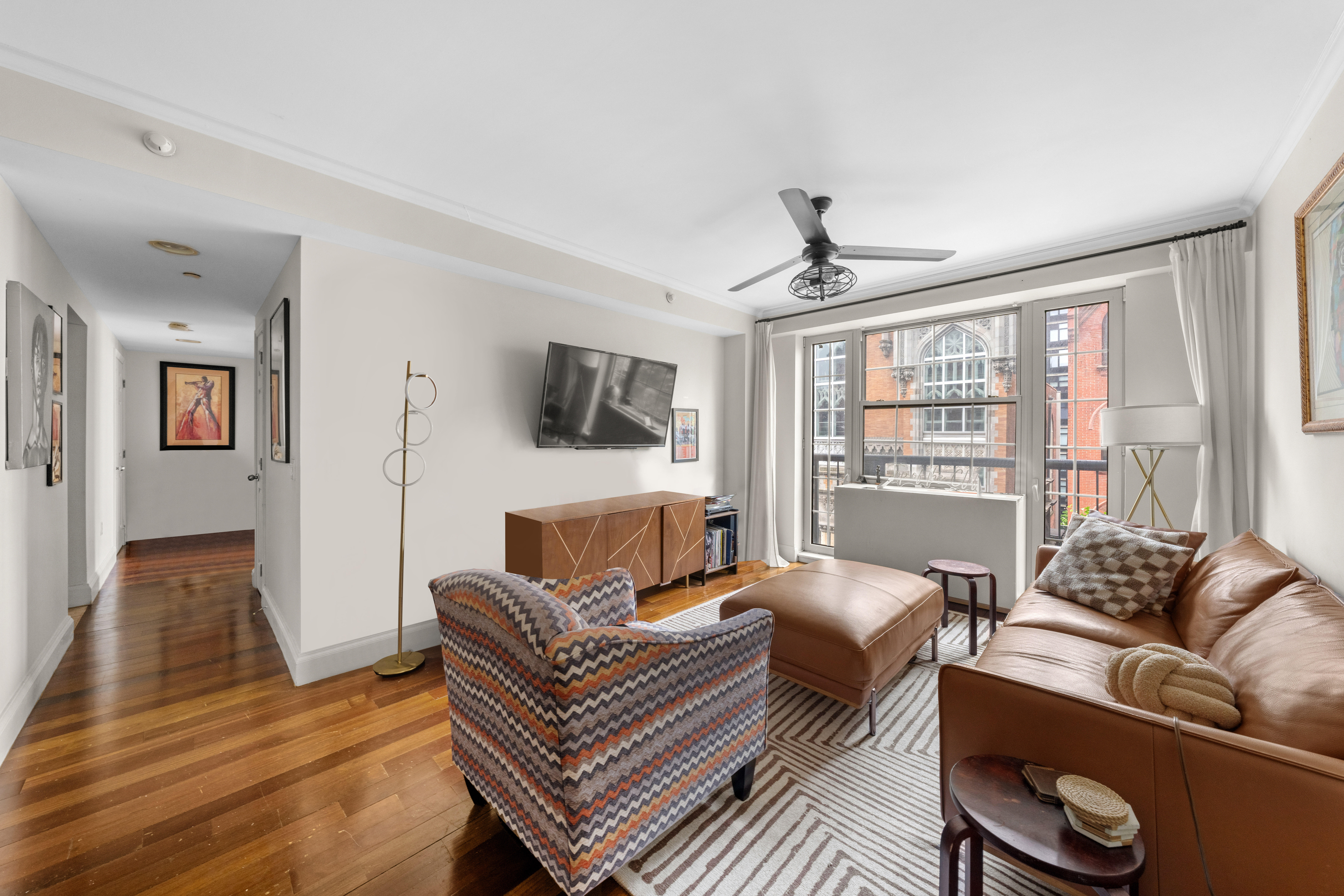 163 St Nicholas Avenue, Unit 4H Manhattan, NY 10026 - Photo 5 of 16 a living room with furniture and a large window