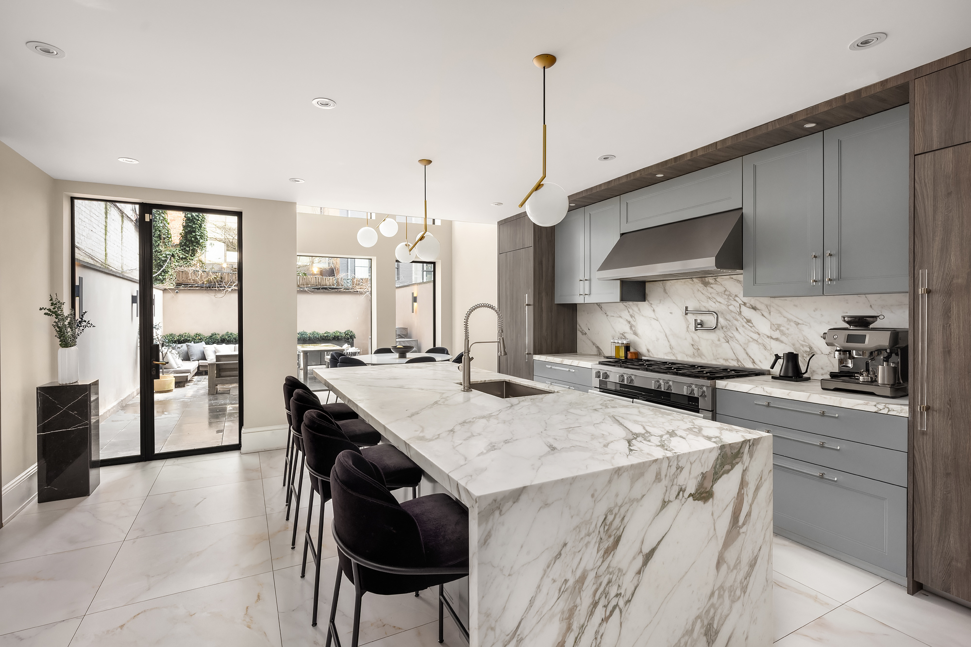 123 East 61st Street Manhattan, NY 10065 - Photo 20 of 31 a kitchen with stainless steel appliances kitchen island granite countertop a stove a sink and a refrigerator