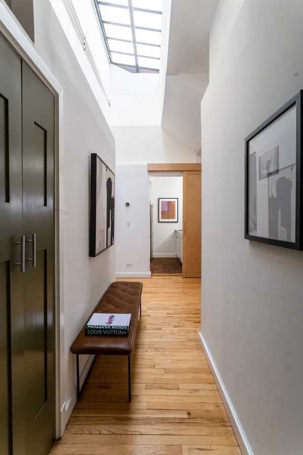 a hallway with table and flowerpot