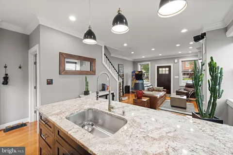 a kitchen with a stove a sink and a refrigerator