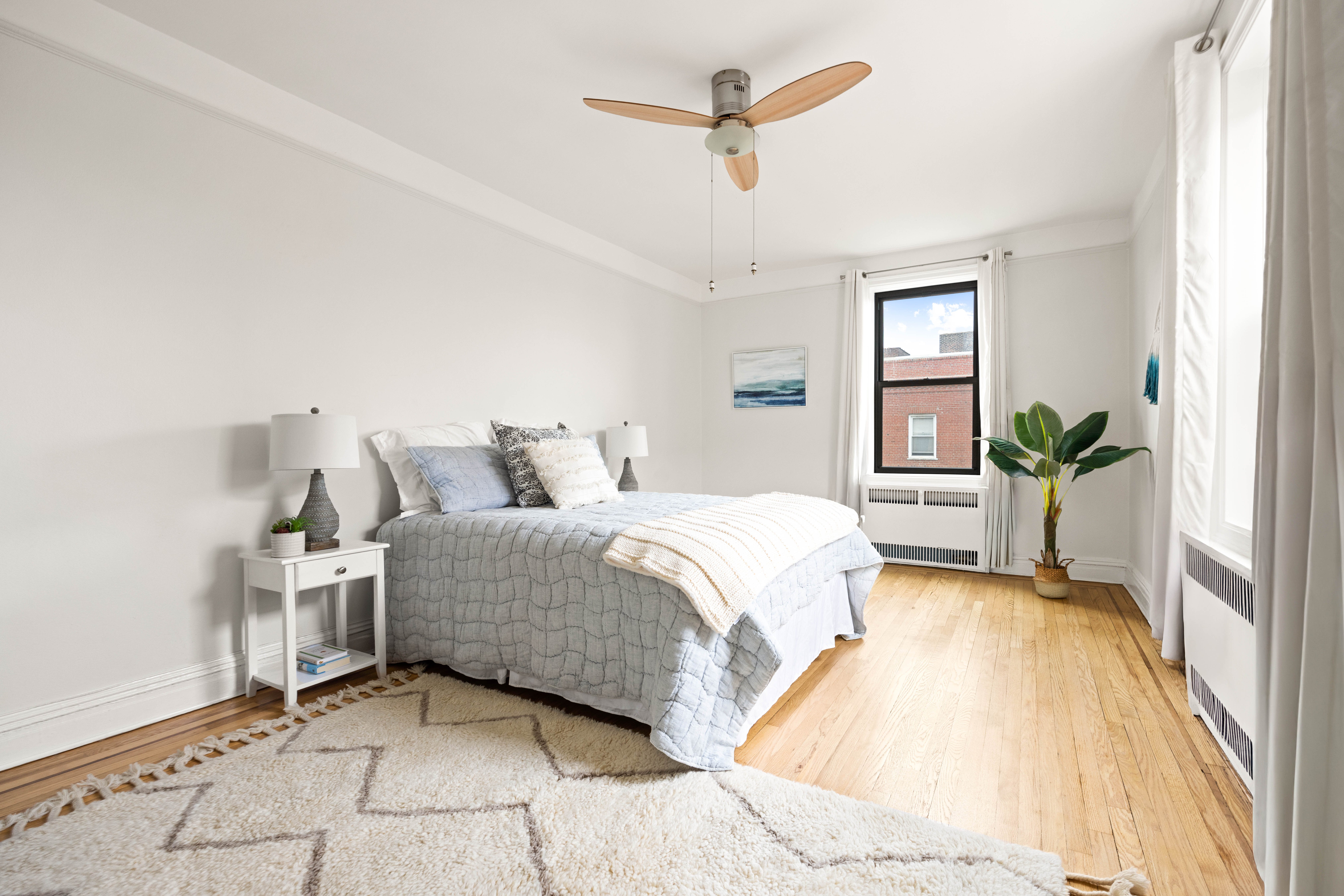 30 Ocean Parkway, Unit 6G Brooklyn, NY 11218 - Photo 8 of 18 a spacious bedroom with a bed and a potted plant