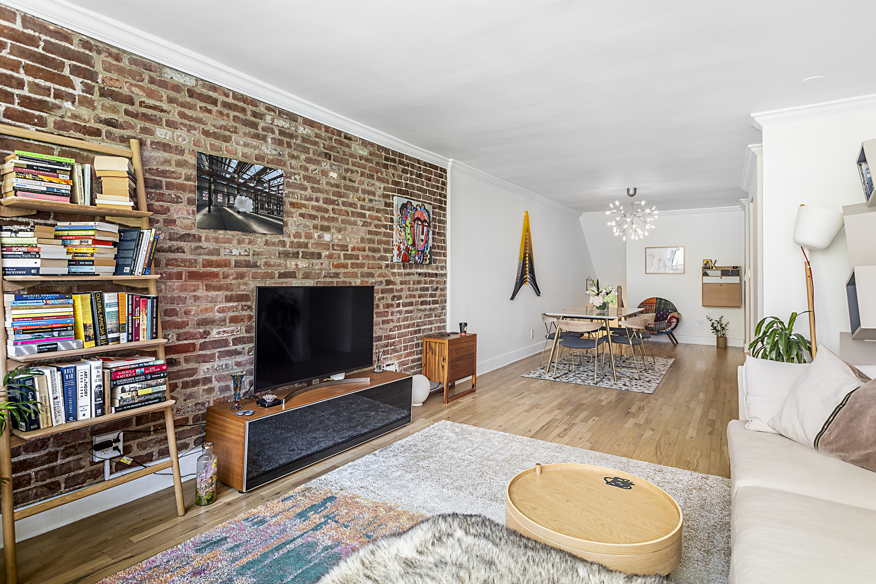 250 West 15th Street, Unit 3C Manhattan, NY 10011 - Photo 2 of 9 a living room with furniture and a flat screen tv