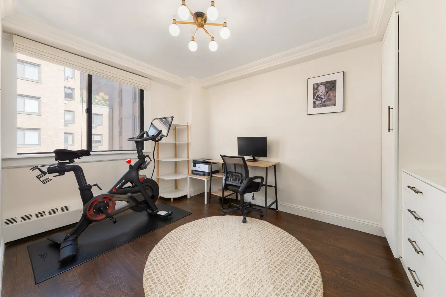 a view of a workspace with furniture and a window