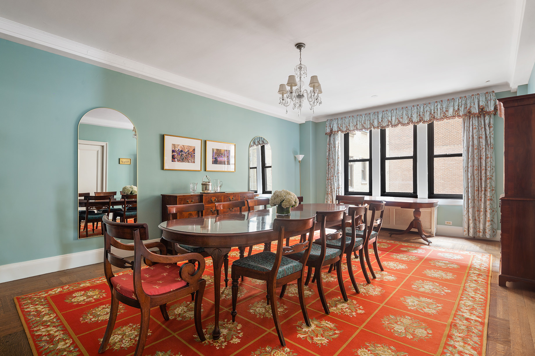 1115 5th Avenue, Unit 5B Manhattan, NY 10128 - Photo 4 of 19 a view of a dining room with furniture and chandelier