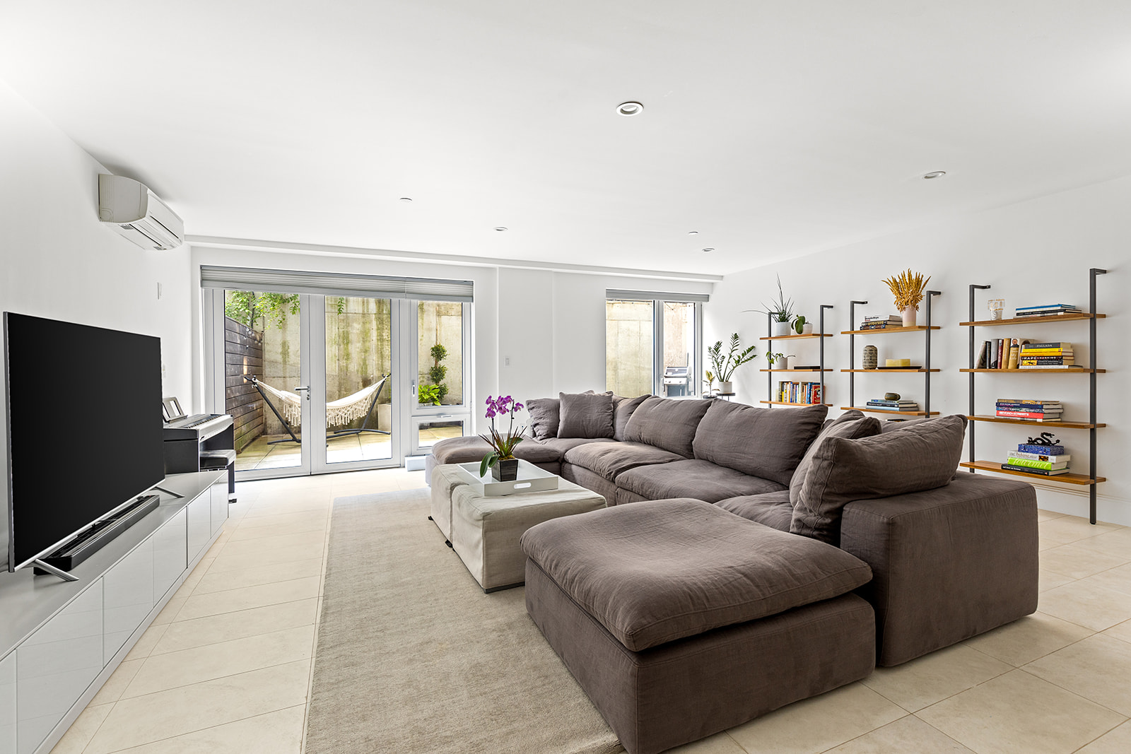 610 Warren Street, Unit GDNB Brooklyn, NY 11217 - Photo 2 of 17 a living room with furniture and a flat screen tv