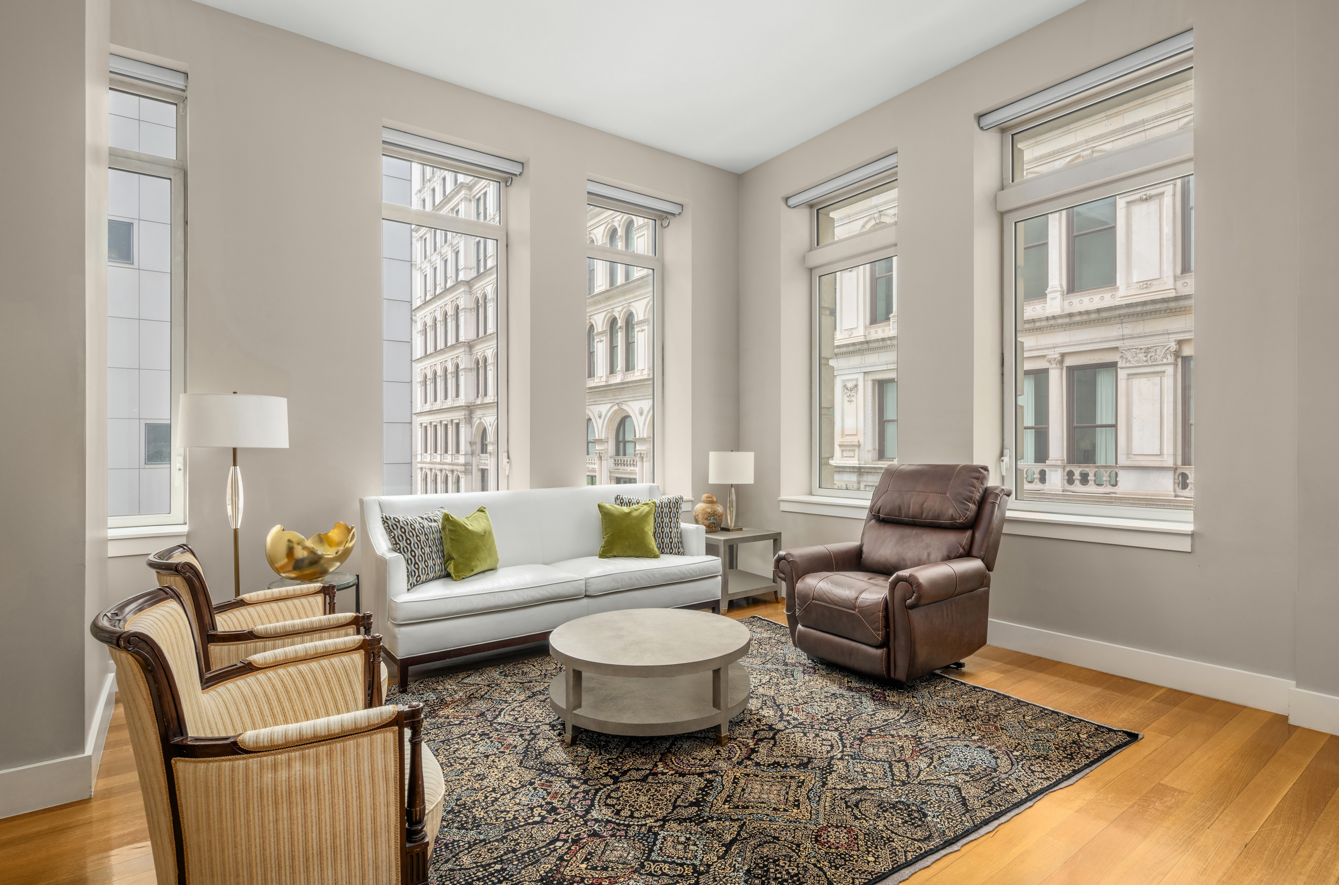 101 Leonard Street, Unit 2E Manhattan, NY 10013 - Photo 4 of 16 a living room with furniture two windows and a coffee table