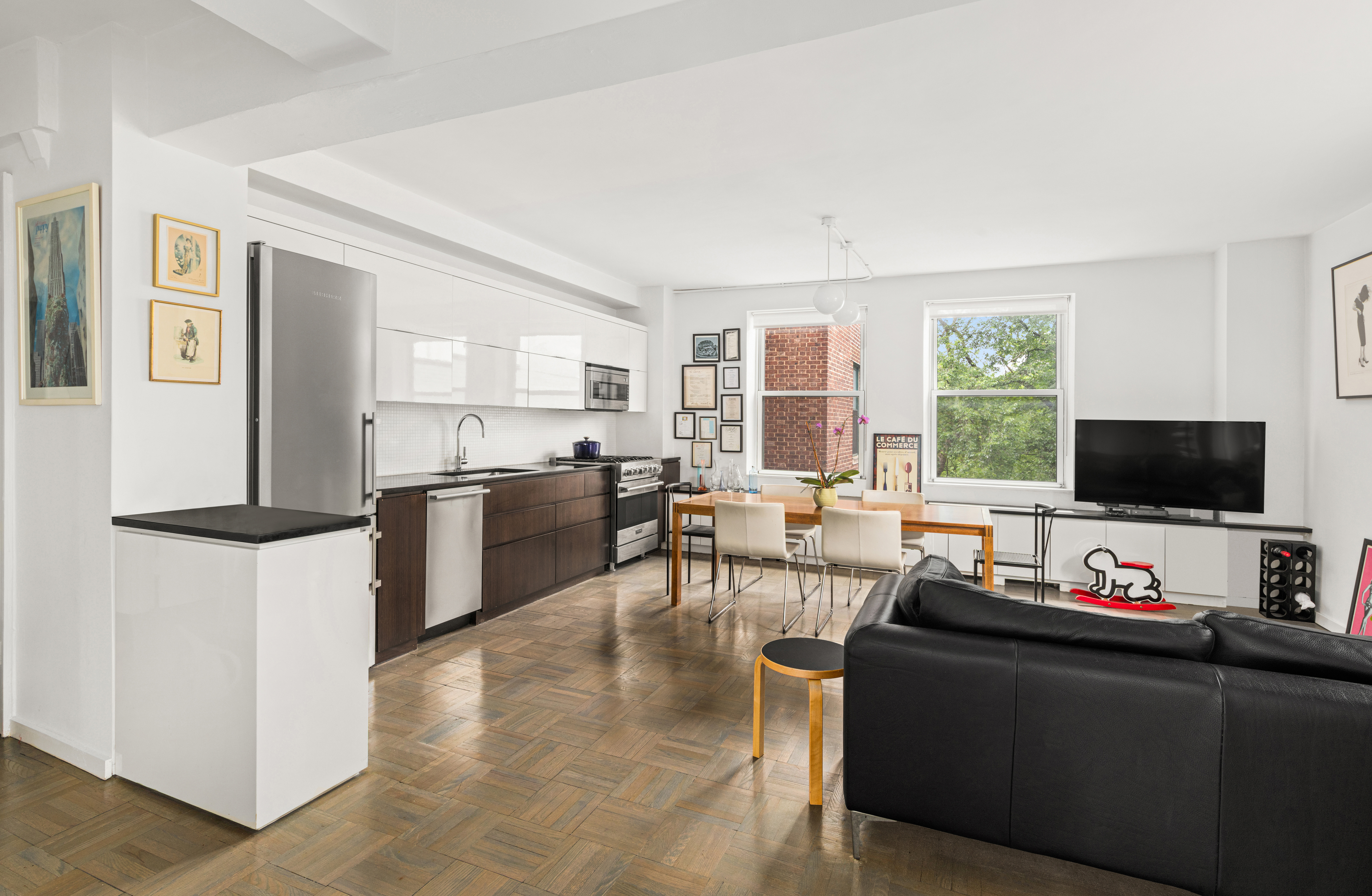 131 Avenue B, Unit 4A Manhattan, NY 10009 - Photo 3 of 11 a living room with furniture and a flat screen tv