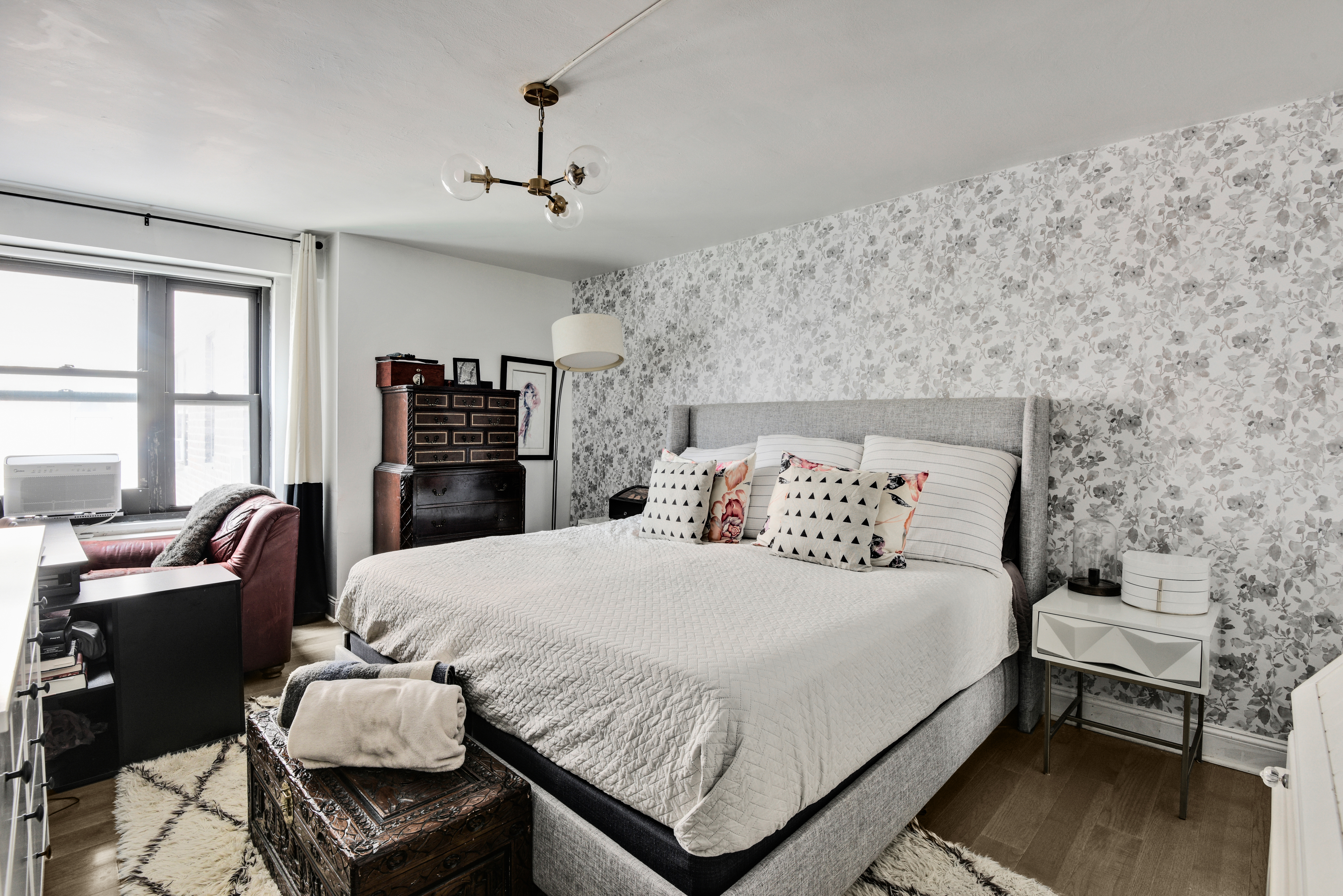 208 East Broadway, Unit J1304 Manhattan, NY 10002 - Photo 7 of 19 a bedroom with a bed and wooden floor