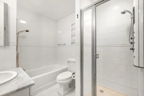 a bathroom with a toilet a sink and shower