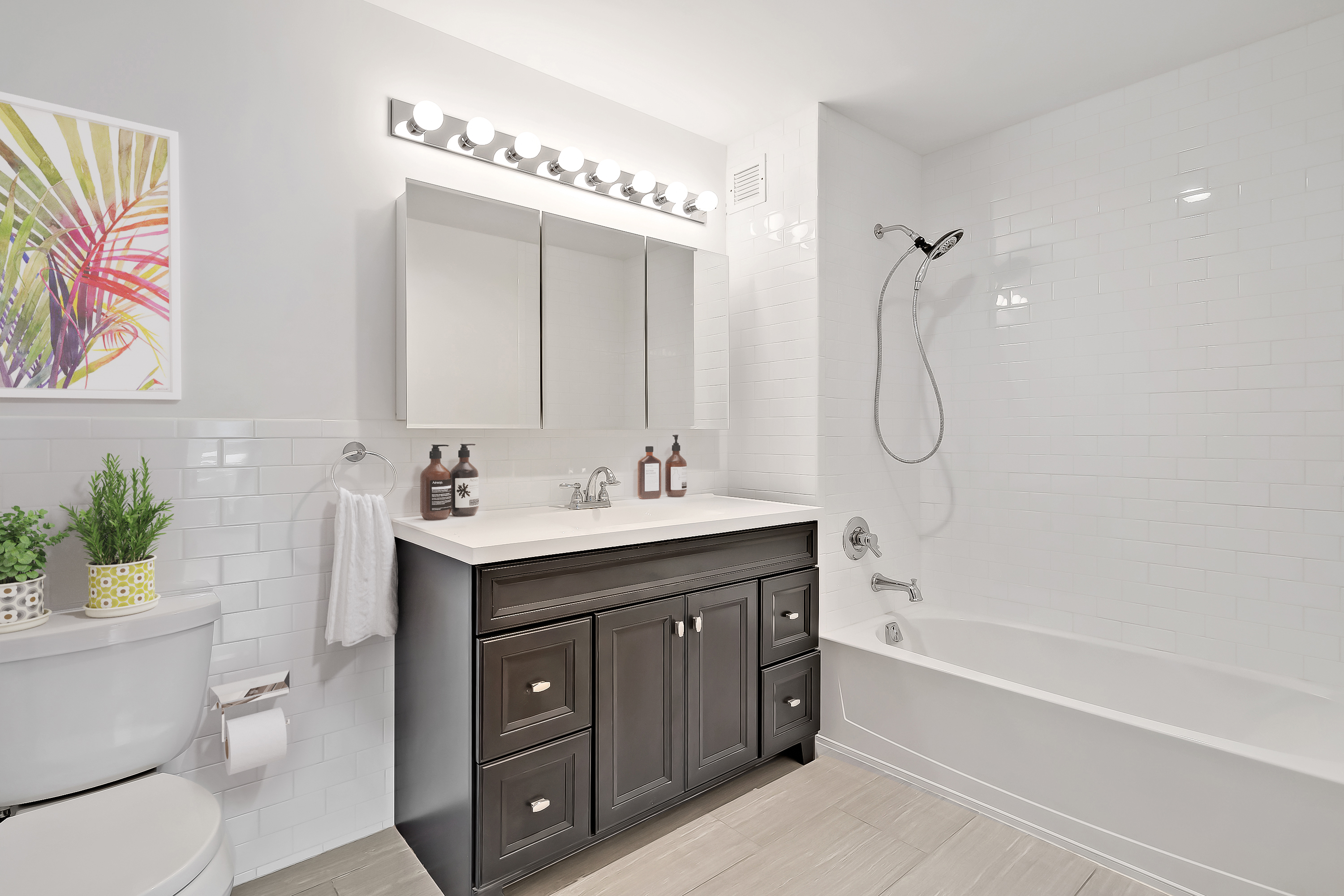 26-20 14th Place, Unit 3C Queens, NY 11102 - Photo 8 of 13 a bathroom with a double vanity sink toilet mirror and bathtub