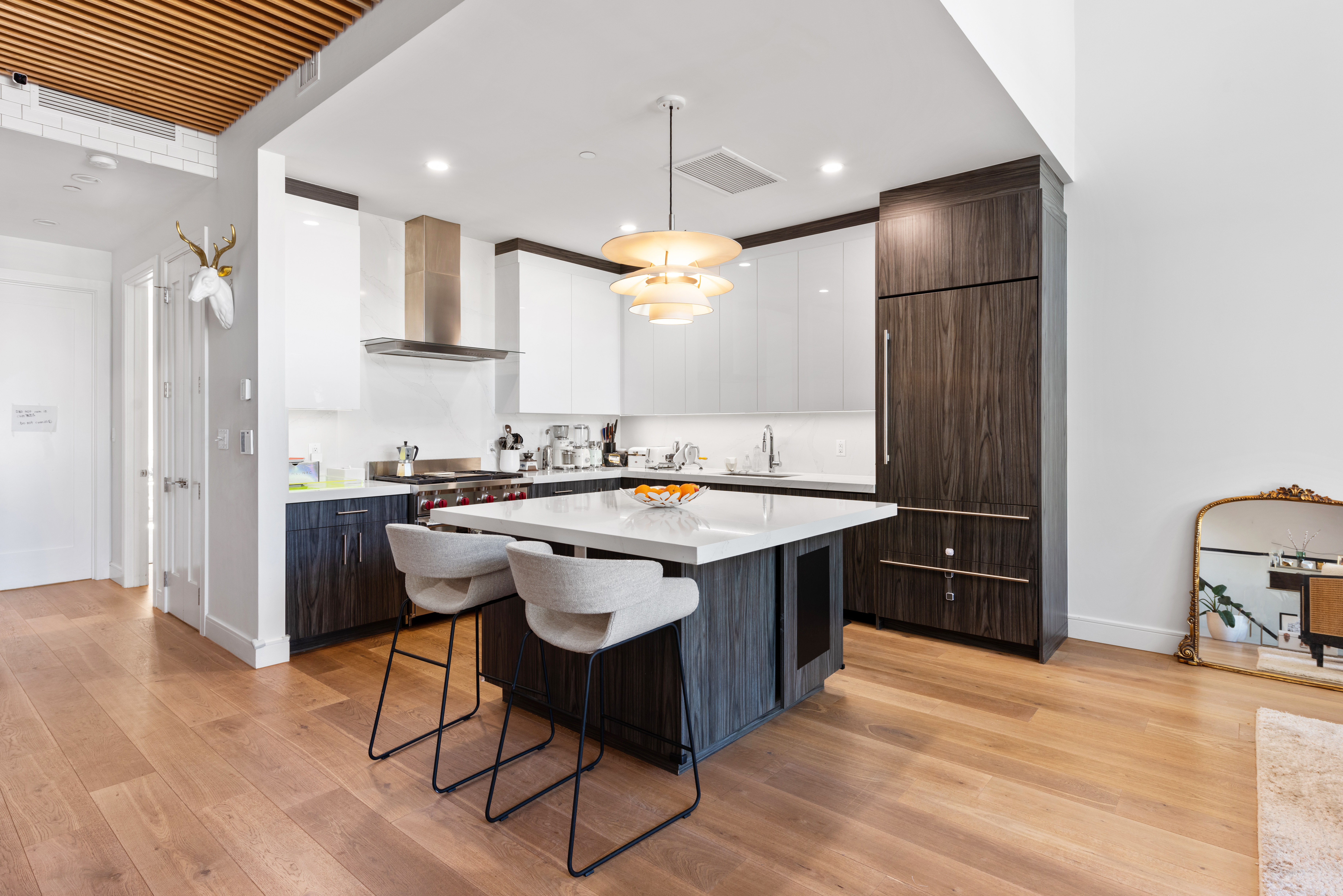 102 Huron Street, Unit 3B Brooklyn, NY 11222 - Photo 5 of 18 a kitchen with stainless steel appliances granite countertop a sink a stove a refrigerator and island with wooden floor