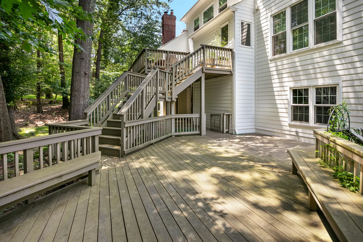 a view of backyard with deck and wooden floor