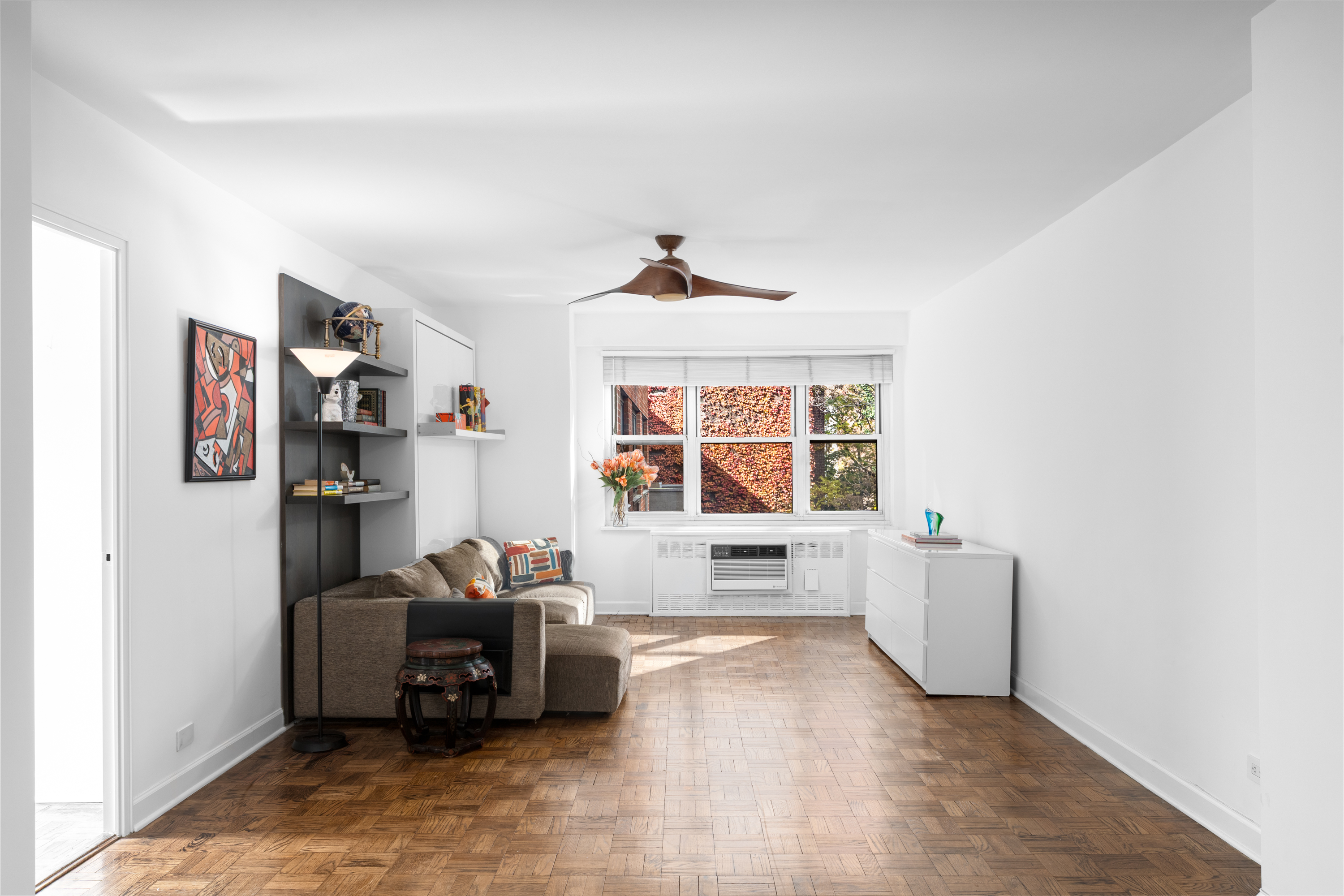 251 East 51st Street, Unit 5A Manhattan, NY 10022 - Photo 4 of 23 a living room with furniture and a flat screen tv