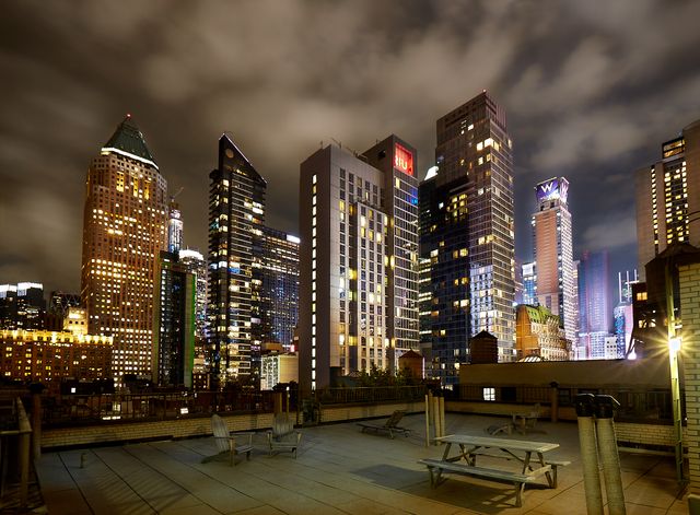 325 West 45th Street, Unit 108 Manhattan, NY 10036 - Photo 8 of 12 a city street filled with lots of traffic and tall buildings