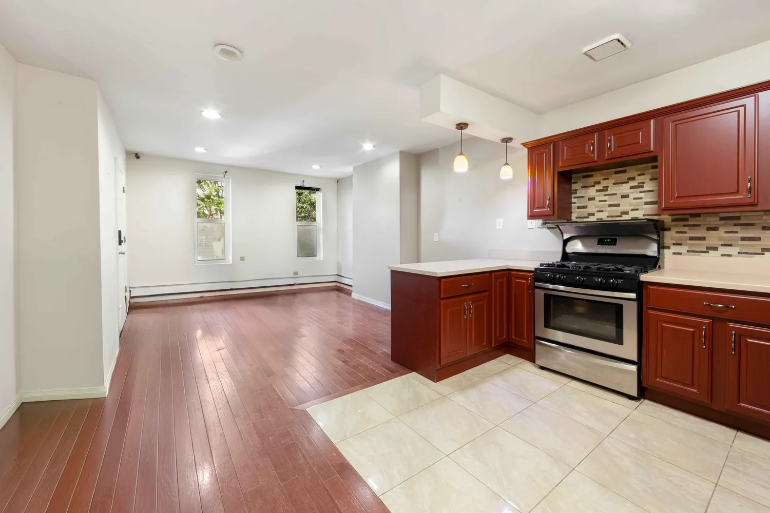 a kitchen with stainless steel appliances a stove a sink and a microwave