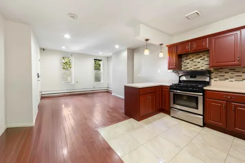 a kitchen with stainless steel appliances a stove a sink and a microwave