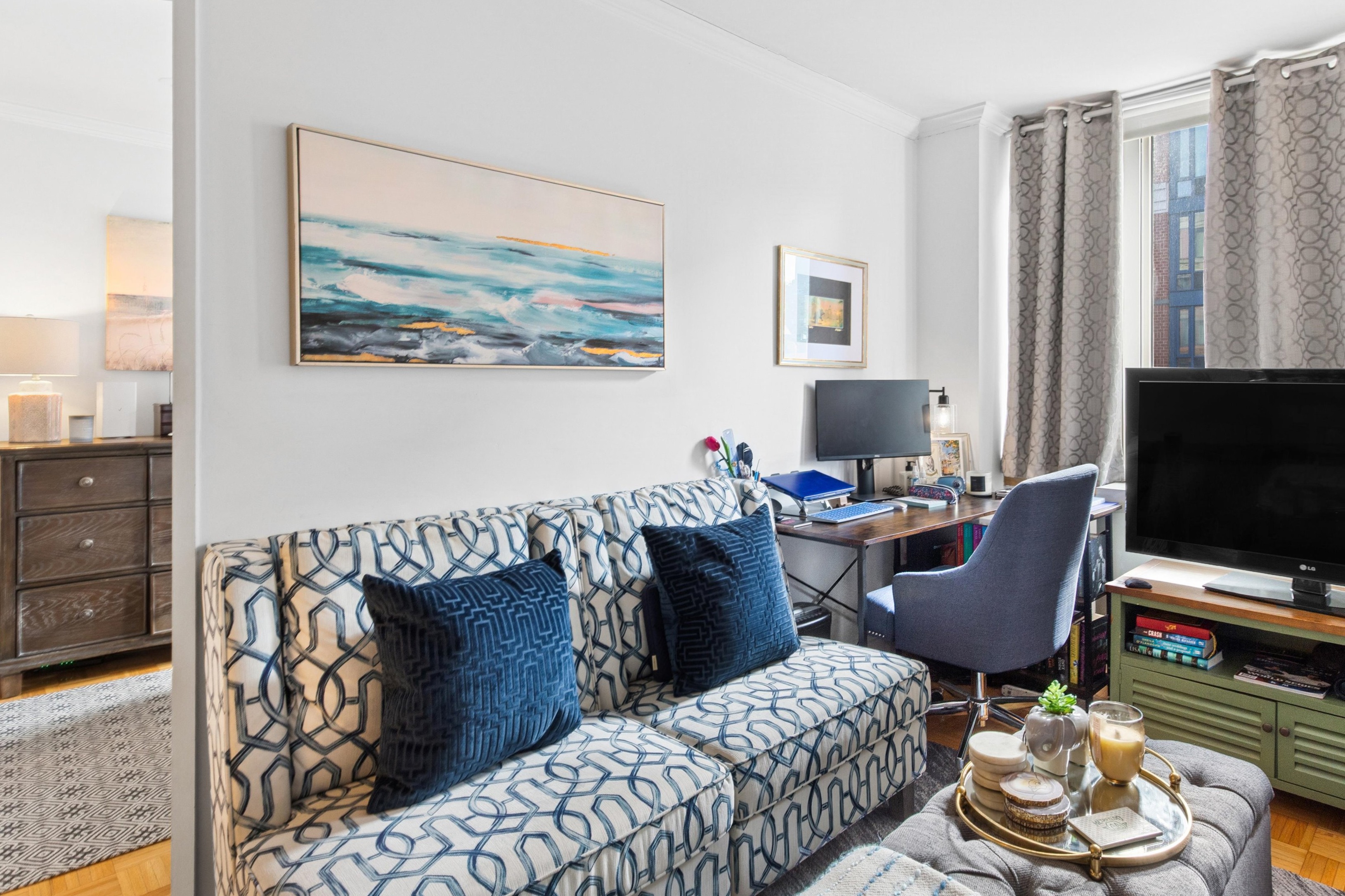 404 East 76th Street, Unit 4M Manhattan, NY 10021 - Photo 2 of 13 a living room with furniture and a flat screen tv