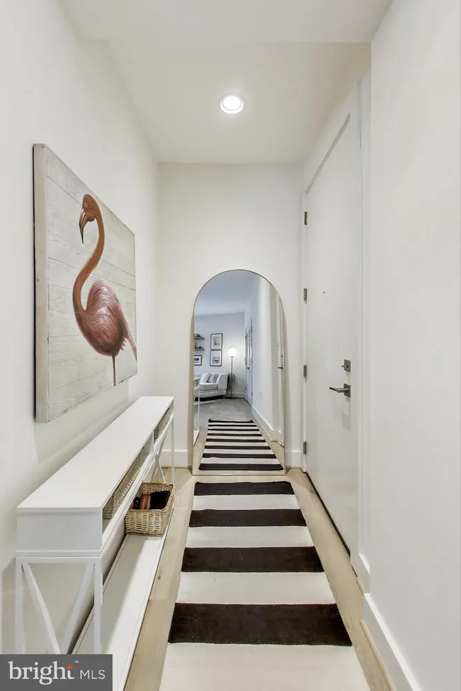 a view of a hallway with paintings on the wall