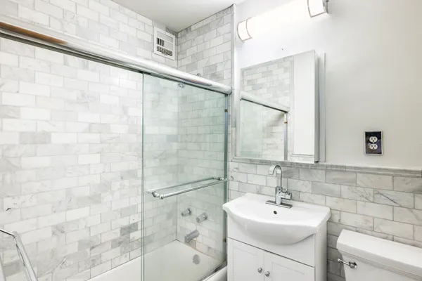 a bathroom with a sink toilet and shower