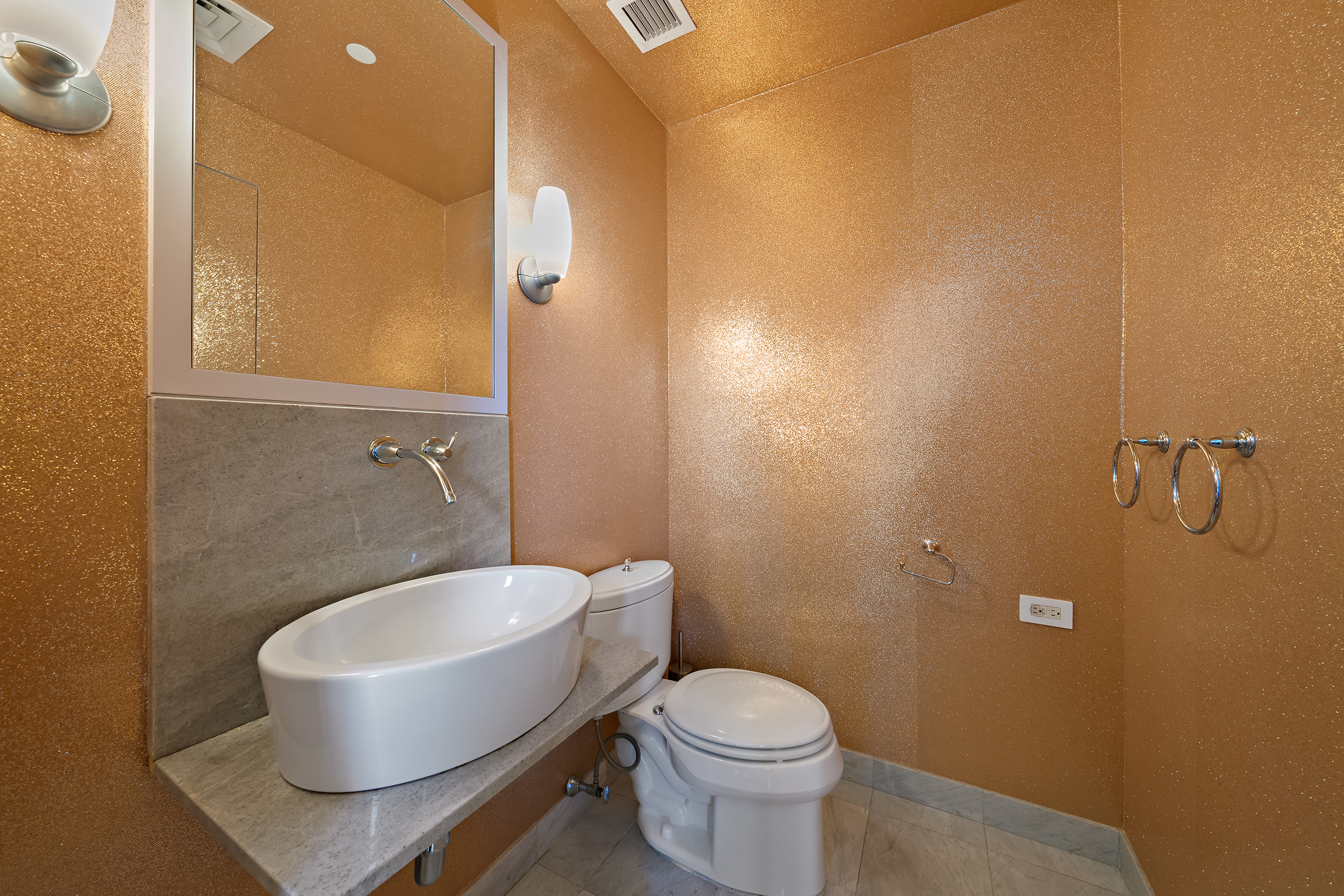 1200 Broadway, Unit PH89 Manhattan, NY 10001 - Photo 45 of 47 a white toilet sitting next to a bathroom sink and a mirror