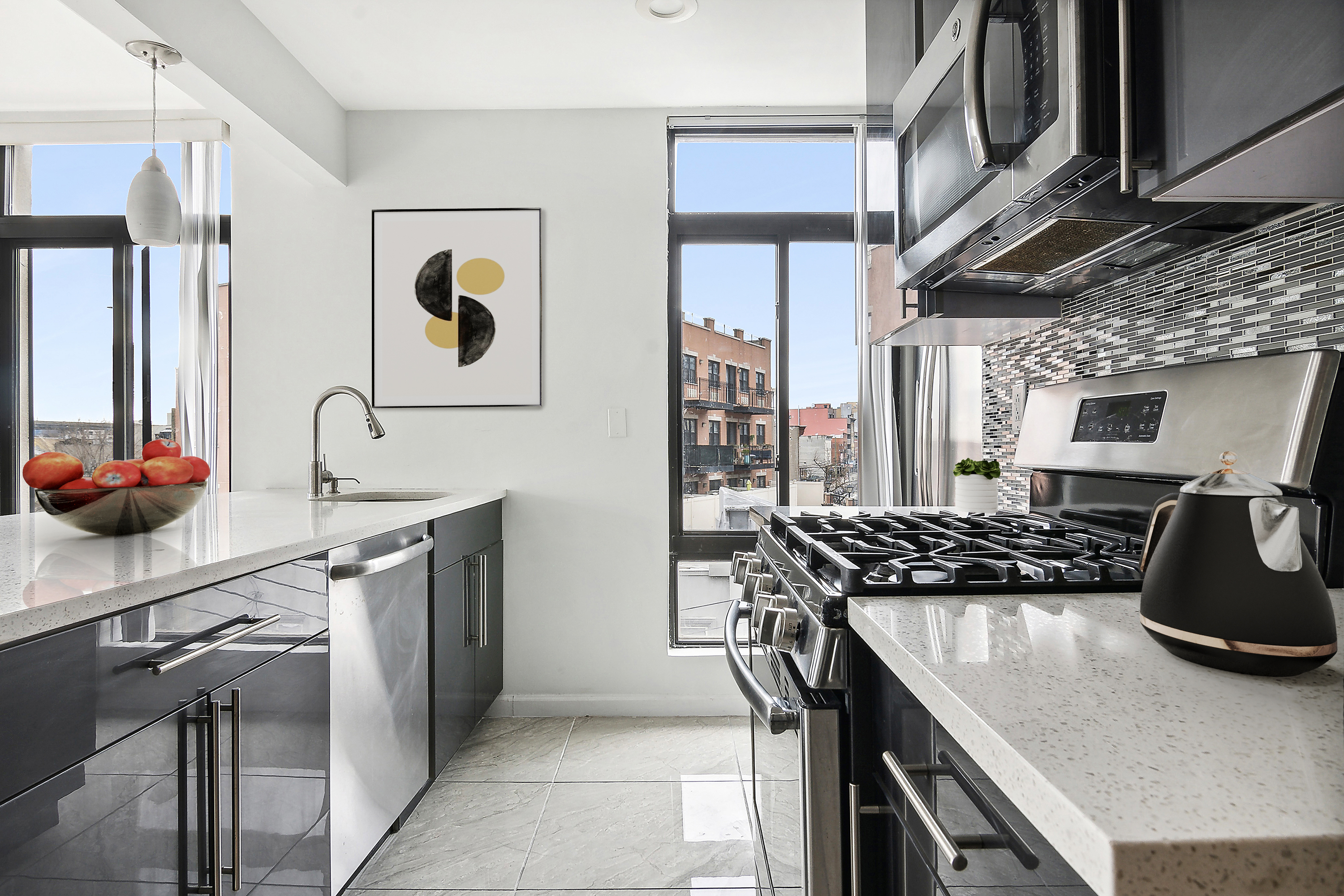 27-16 18th Street, Unit 2 Queens, NY 11102 - Photo 4 of 6 a kitchen with stainless steel appliances granite countertop a stove and a sink
