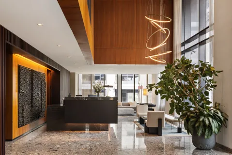 a dining room with furniture and a potted plant