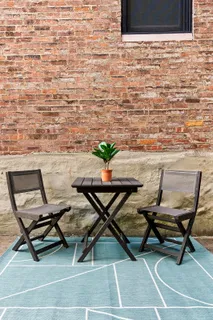 a dining room with furniture and a potted plant